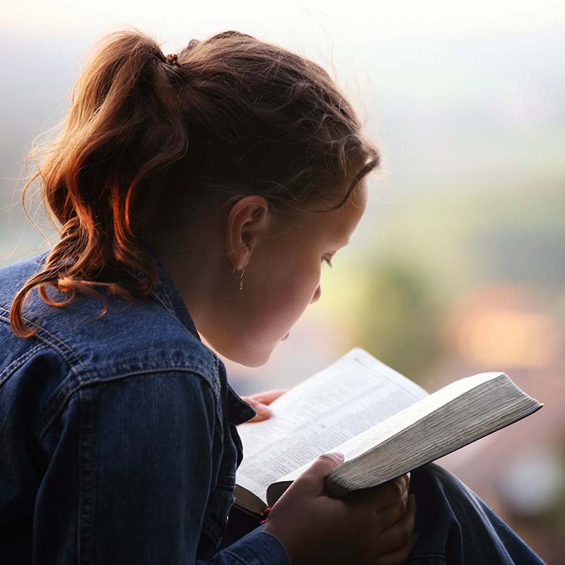 Child reads from the bible